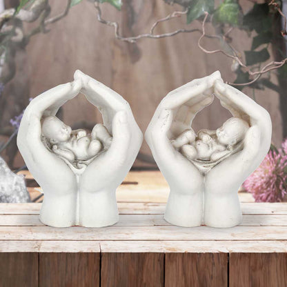 Set of Two Small Shelter 7cm Baby in Cradled Hands Figurines 7